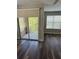 Spacious living room with hardwood floors and sliding door to the screened balcony at 12631 Silverdale St, Tampa, FL 33626