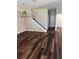 Spacious living room featuring wood flooring, staircase, and contemporary chandelier at 12631 Silverdale St, Tampa, FL 33626