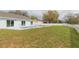 A backyard featuring an in-ground swimming pool and a large grassy area for outdoor activities at 12910 Longcrest Dr, Riverview, FL 33579