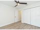 Cozy bedroom with a ceiling fan, closet, and modern wood-look flooring at 12910 Longcrest Dr, Riverview, FL 33579