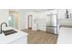 A contemporary kitchen featuring white cabinetry, stainless steel appliances, and a center island with a sink at 12910 Longcrest Dr, Riverview, FL 33579