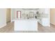 A modern kitchen featuring white cabinetry, stainless steel appliances, a large island, and stylish countertops at 12910 Longcrest Dr, Riverview, FL 33579