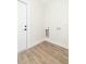 Laundry room featuring light-wood flooring and a conveniently placed utility hookups at 12910 Longcrest Dr, Riverview, FL 33579