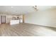 Open floor plan showing spacious living room with modern lighting that transitions into the kitchen and dining space at 12910 Longcrest Dr, Riverview, FL 33579