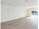 Large living room with a view of the outdoor pool through sliding glass doors and modern lighting fixture at 12910 Longcrest Dr, Riverview, FL 33579