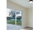 View of patio through sliding glass door with a white picket fence in the background at 12910 Longcrest Dr, Riverview, FL 33579
