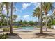 A lagoon style community pool is surrounded by palm trees and covered seating areas, perfect for cooling off at 13421 Lake Monroe Pl, Riverview, FL 33579
