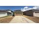 Detached two-car garage with a long driveway and minimal landscaping at 13421 Lake Monroe Pl, Riverview, FL 33579