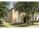 Charming home with front porch, black framed windows, and mature trees at 13421 Lake Monroe Pl, Riverview, FL 33579