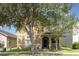 Charming home with front porch, black framed windows, and mature trees at 13421 Lake Monroe Pl, Riverview, FL 33579