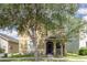 Charming home with front porch, black framed windows, and mature trees at 13421 Lake Monroe Pl, Riverview, FL 33579