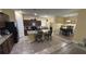 Open kitchen and dining area with a granite island, stainless appliances, and tile floors at 13421 Lake Monroe Pl, Riverview, FL 33579
