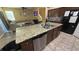 Kitchen island featuring stainless steel appliances, granite countertops, and tile flooring at 13421 Lake Monroe Pl, Riverview, FL 33579