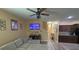 Cozy living room featuring a plush sectional couch, television, and a view to the kitchen at 13421 Lake Monroe Pl, Riverview, FL 33579