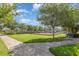 Community playground with swings and slide, featuring shade trees and benches for families at 13421 Lake Monroe Pl, Riverview, FL 33579