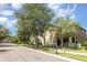 Inviting two-story townhome with screened porch, mature trees, and green lawn for relaxed neighborhood living at 13421 Lake Monroe Pl, Riverview, FL 33579