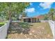 Fenced backyard featuring a large tree and screen enclosed patio at 13437 Beechberry Dr, Riverview, FL 33579