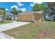 Side view of a single story home with a two car garage and well manicured lawn at 13437 Beechberry Dr, Riverview, FL 33579