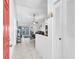 Inviting foyer with tiled flooring leading to a living area with sliding glass doors at 13437 Beechberry Dr, Riverview, FL 33579