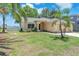 Single story home featuring a well manicured lawn and tropical landscaping at 13437 Beechberry Dr, Riverview, FL 33579