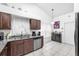 Functional kitchen featuring granite countertops, wood cabinets, and updated appliances at 13437 Beechberry Dr, Riverview, FL 33579