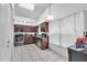Well-lit kitchen features wood cabinets, stainless steel appliances and neutral-colored tile flooring at 13437 Beechberry Dr, Riverview, FL 33579