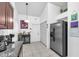 Efficient kitchen with granite countertops, stainless steel refrigerator, and ample cabinet space at 13437 Beechberry Dr, Riverview, FL 33579
