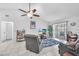 Relaxing living room area with tile floors, ceiling fan, and access to outdoor space at 13437 Beechberry Dr, Riverview, FL 33579