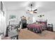 Spacious main bedroom with neutral colored carpet, ceiling fan, and two windows for natural lighting at 13437 Beechberry Dr, Riverview, FL 33579