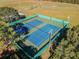 Aerial view of community tennis courts, with green fencing and lights at 13437 Beechberry Dr, Riverview, FL 33579
