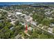 Aerial view of a house with nearby commercial areas and waterways at 13598 Park Blvd, Seminole, FL 33776