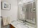 Stylish bathroom vanity with a gray marble countertop and a large framed mirror at 13598 Park Blvd, Seminole, FL 33776