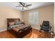 Neutral bedroom with hardwood floors, a comfortable bed, plantation shutters, and a ceiling fan at 13598 Park Blvd, Seminole, FL 33776