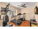 Home gym with hardwood floors and ample natural light, complete with a variety of exercise equipment at 13598 Park Blvd, Seminole, FL 33776