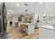 Open kitchen features an island with seating, granite countertops, and stainless steel appliances at 13598 Park Blvd, Seminole, FL 33776
