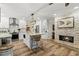 Well-equipped kitchen featuring modern appliances, center island with bar seating, and a cozy fireplace at 13598 Park Blvd, Seminole, FL 33776