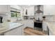 Bright and updated kitchen with white cabinets, granite countertops, and stainless steel appliances at 13598 Park Blvd, Seminole, FL 33776