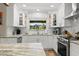 Beautiful bright kitchen with white cabinets, granite countertops, stainless steel appliances, and white subway tile at 13598 Park Blvd, Seminole, FL 33776
