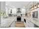 Bright kitchen with stainless steel appliances, white cabinets, granite countertops, and a center island at 13598 Park Blvd, Seminole, FL 33776