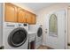 Functional laundry room with a washer, dryer, utility sink, and ironing board at 13598 Park Blvd, Seminole, FL 33776