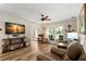 Spacious living area featuring stylish decor, wood flooring, comfortable seating, and a bright ambiance at 13598 Park Blvd, Seminole, FL 33776