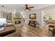 Cozy living room with stone fireplace, hardwood floors, comfortable seating, and a warm ambiance at 13598 Park Blvd, Seminole, FL 33776