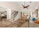 Bright living room with vaulted ceilings, wood floors, comfortable seating, and staircase at 13598 Park Blvd, Seminole, FL 33776