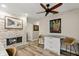 Open living area featuring a stacked stone fireplace, bar seating, and neutral tones at 13598 Park Blvd, Seminole, FL 33776