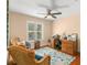 Bright office with hardwood floors, and a charming seating area near a window at 13598 Park Blvd, Seminole, FL 33776