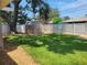 Backyard featuring a shed, green grass, large shade tree and a privacy fence at 13725 Bermuda Dr, Seminole, FL 33776
