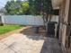 Backyard showcasing the stone patio, privacy fence and mature trees, perfect for outdoor activities at 13725 Bermuda Dr, Seminole, FL 33776