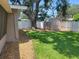Backyard featuring a shed, green grass, large shade tree and a privacy fence at 13725 Bermuda Dr, Seminole, FL 33776