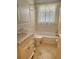 Well-lit bathroom featuring a vanity with marble countertops, tiled floors, and a shower-tub combination at 13725 Bermuda Dr, Seminole, FL 33776