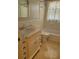 Classic bathroom with a marble countertop vanity, tiled floors, and a shower-tub combination at 13725 Bermuda Dr, Seminole, FL 33776